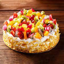 Almond fruit cake garnished with fruits and almonds